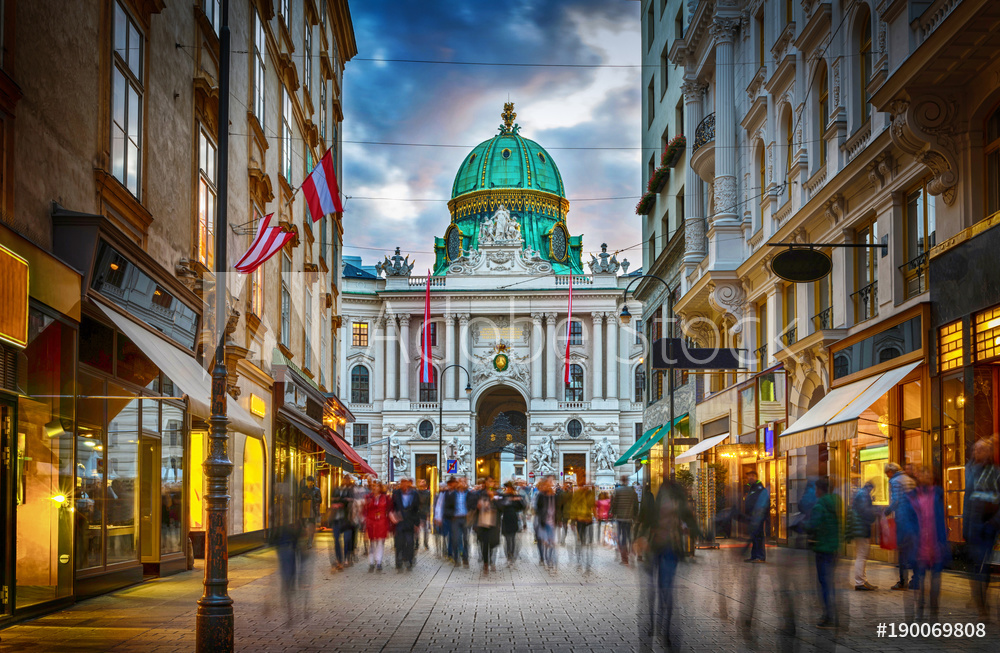 The pedestrian zone Herrengasse with a view towards imperial Hofburg palace in Vienna, Austria.