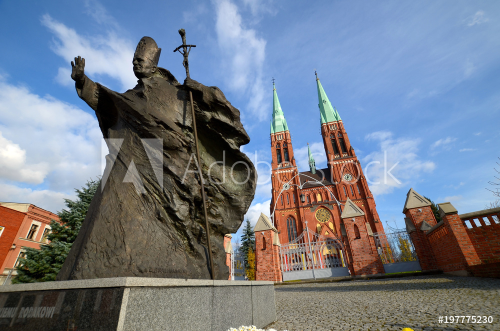 Statue of John Paul II against the background of the cathedral (Rybnik, Poland)