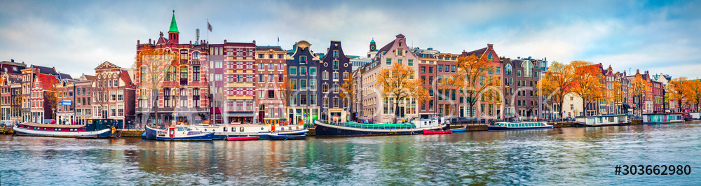 Panoramic autumn view of Amsterdam city. Famous Dutch channels and great cityscape. Colorful morning scene of Netherlands, Europe. Traveling concept background.