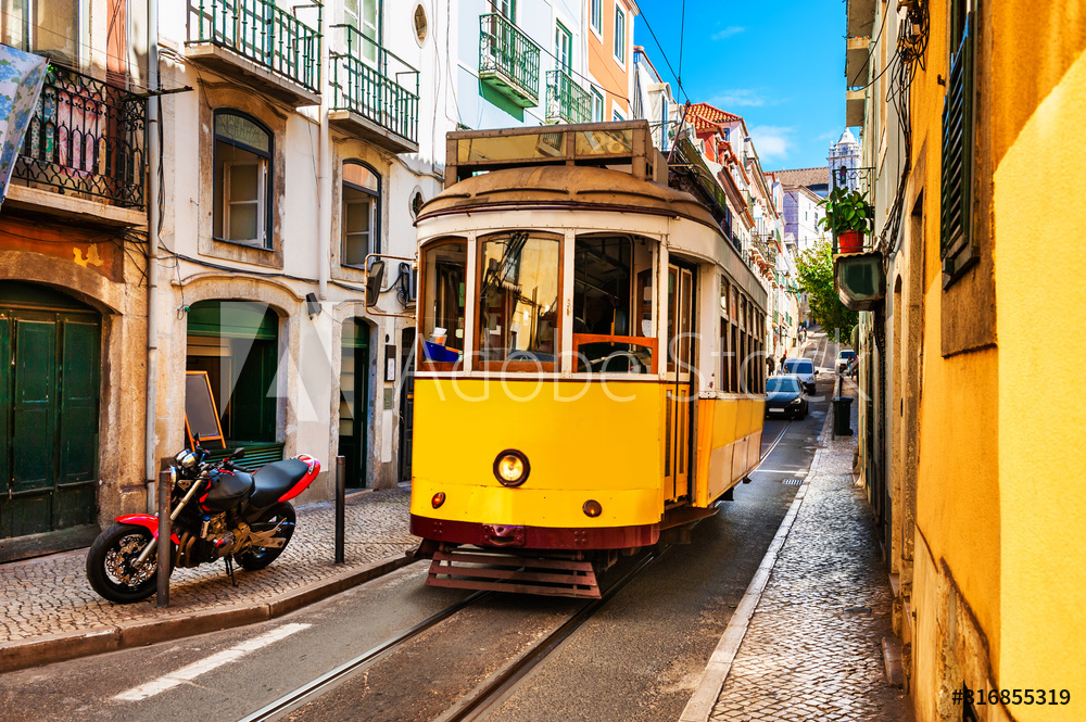 Yellow vintage tram on the street in Lisbon, Portugal. Famous travel destination