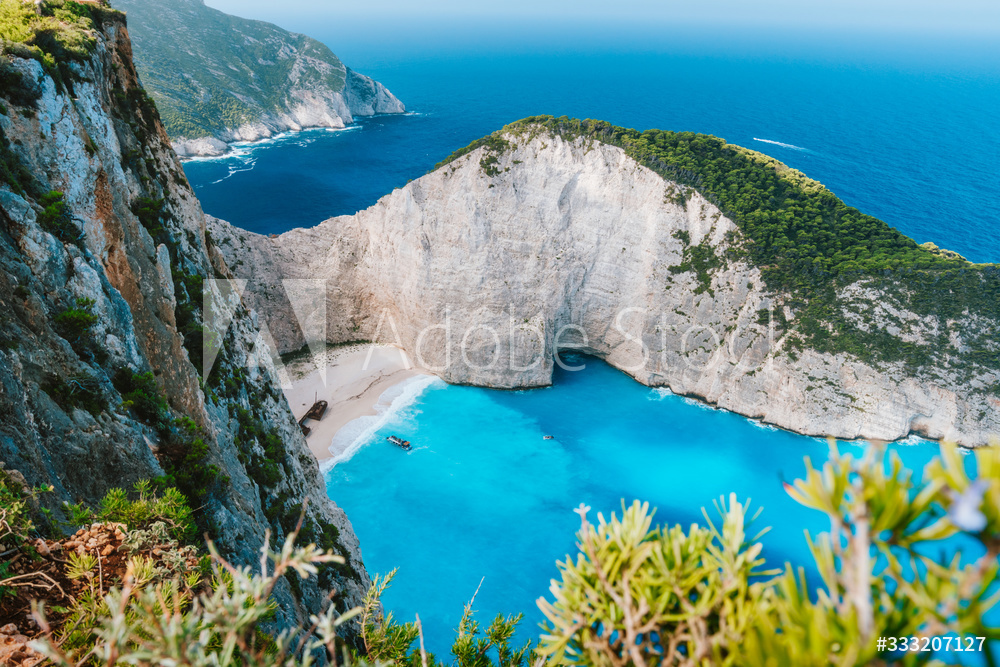 Navagio beach or Shipwreck bay. Turquoise water and pebble white beach in morning light. Famous landmark of Zakynthos island, Greece