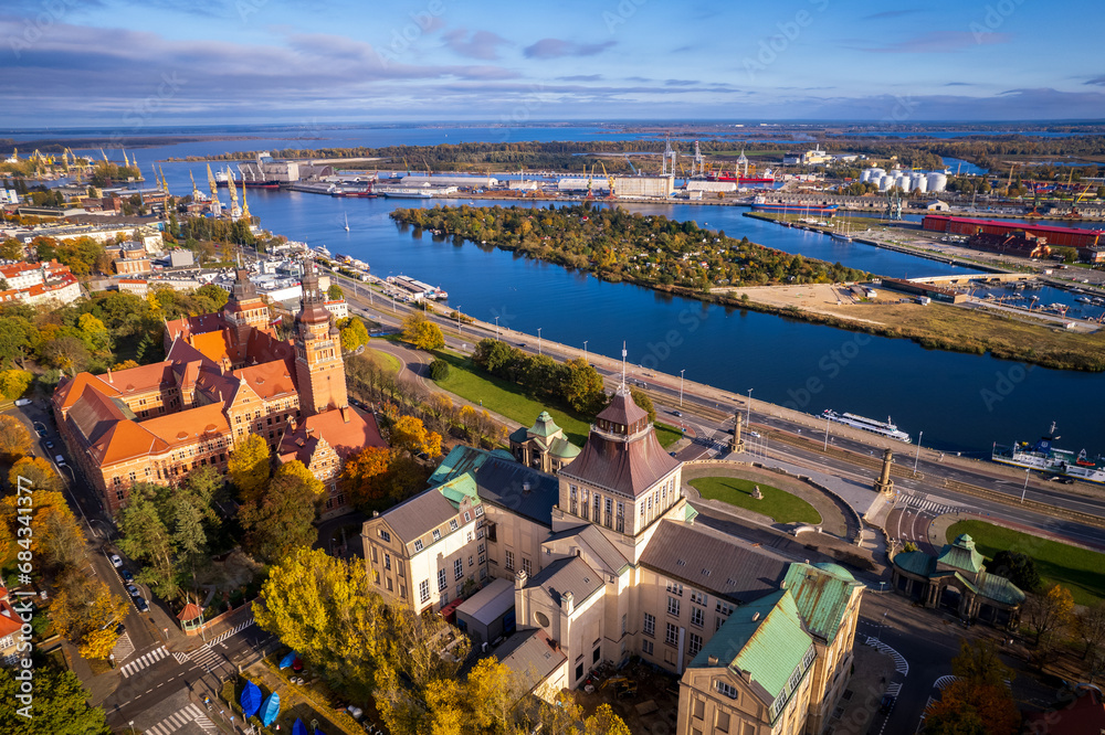 Szczecin from a bird's eye view on a sunny day. View of the city from the Oder River. City buildings, the seaport in Szczecin and its most characteristic places.
